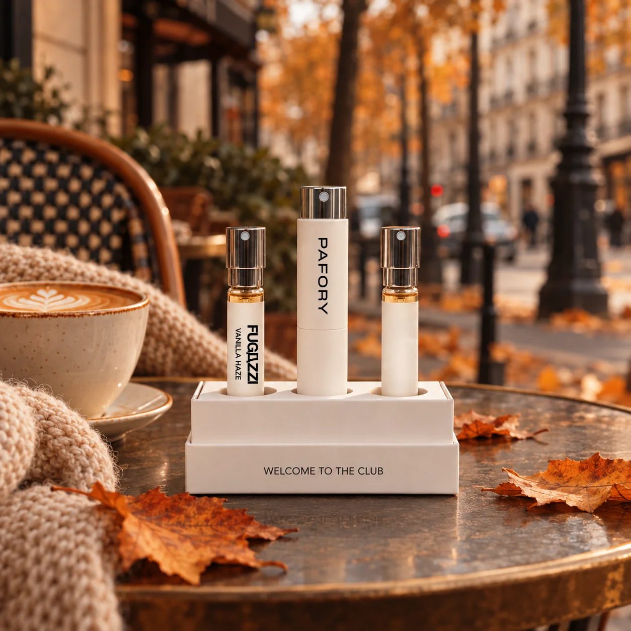 Member Box with the white PAFORY case and the 8 ml Fugazzi Vanilla Haze scent on a café table in autumn, next to a cappuccino