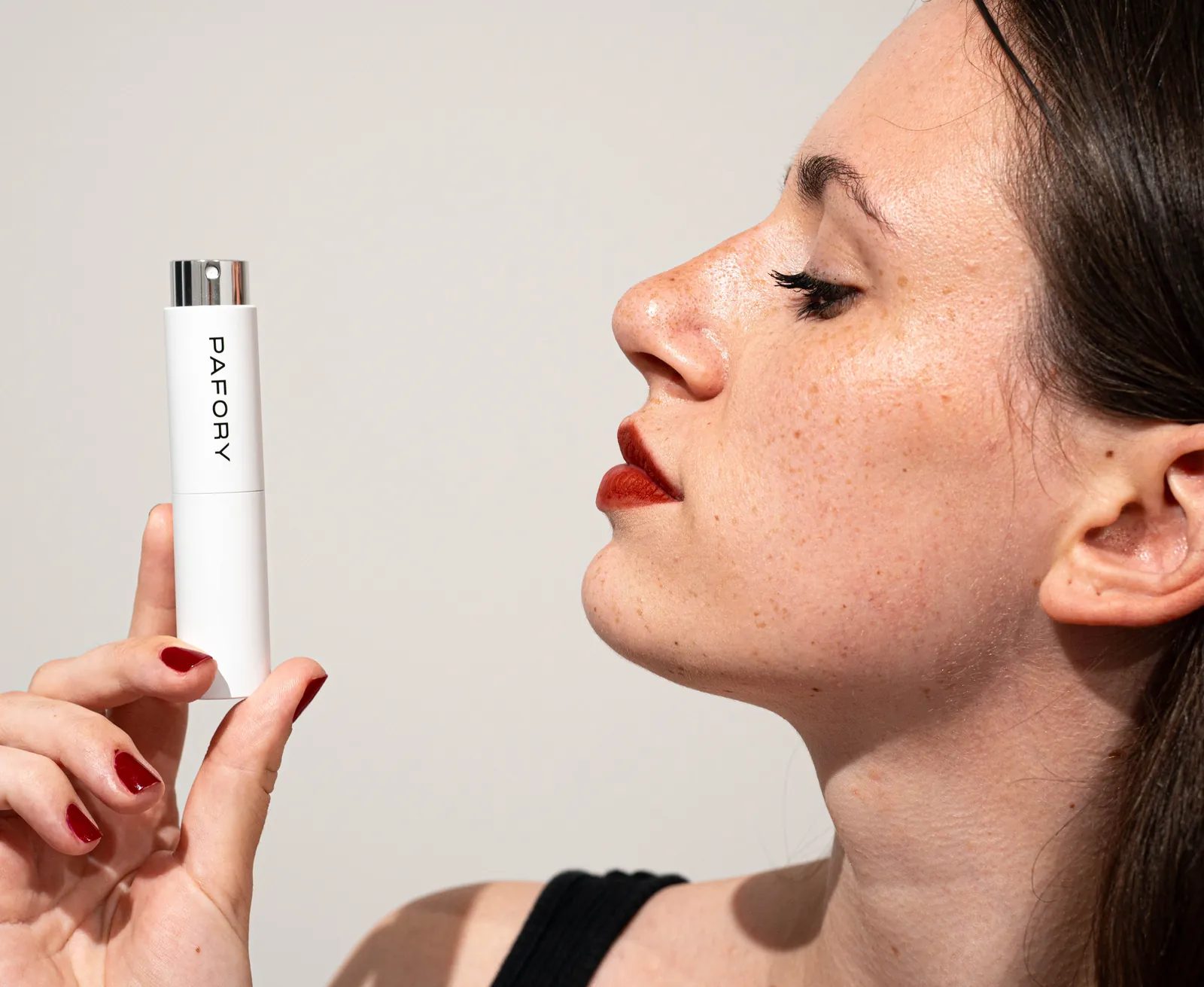 Woman holding the white PAFORY case in front of her face